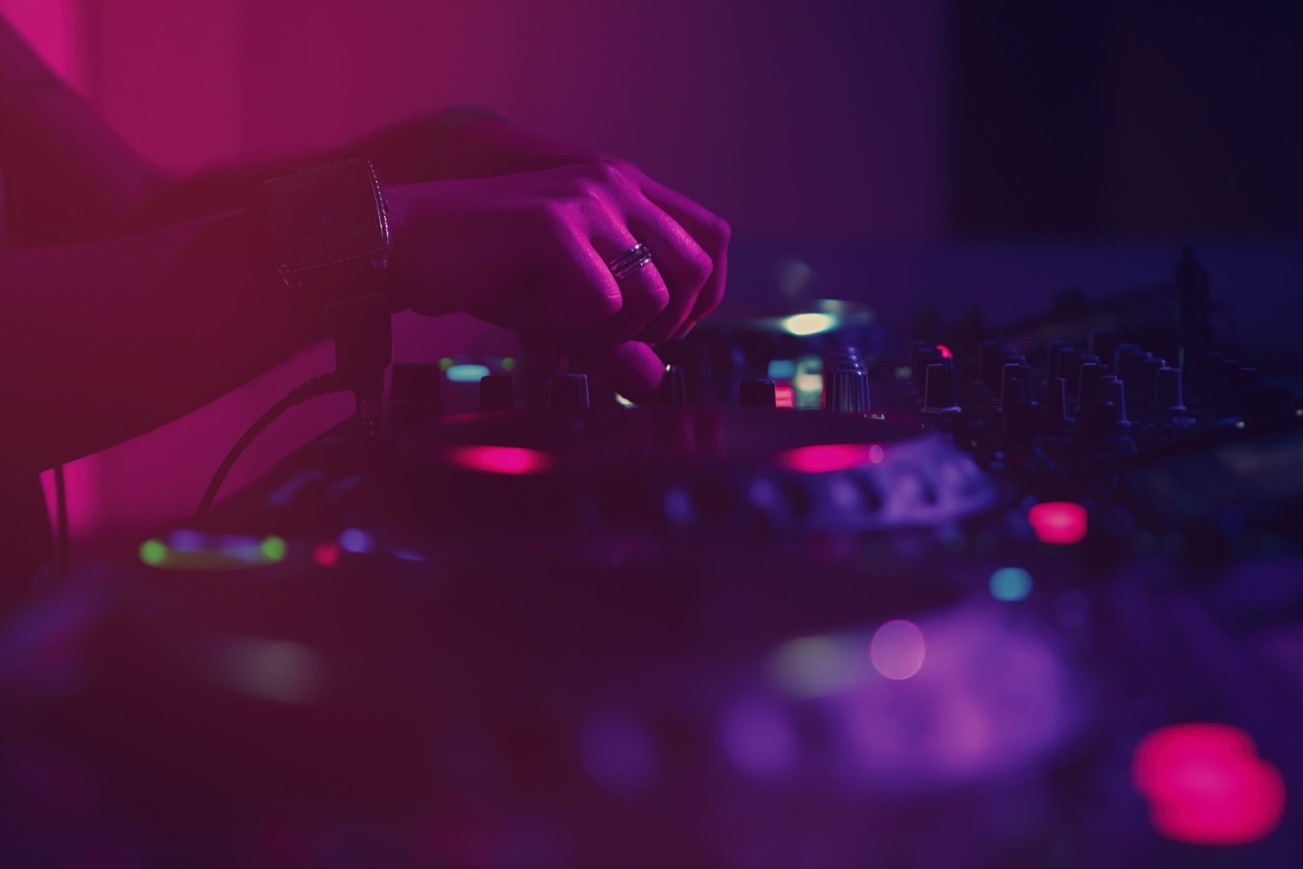 Close-up of a DJ mixing music on a professional turntable at a high-energy dance and night club at Blue Martini Brickell.